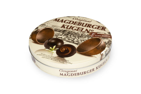 Magdeburger Kugel – Die Otto von Guericke-Metallkugel in edler Papp-Runddose  Feine Pralinen aus Edelbitterschokolade, gefüllt mit zartschmelzendem Sahnetrüffel - großer Freisteller